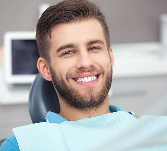 Smiling man in dental chair in Bangor dental office