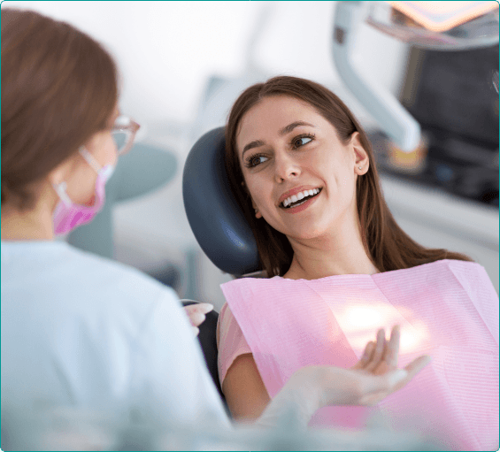 Woman in dental chair talking to her Bangor dentist